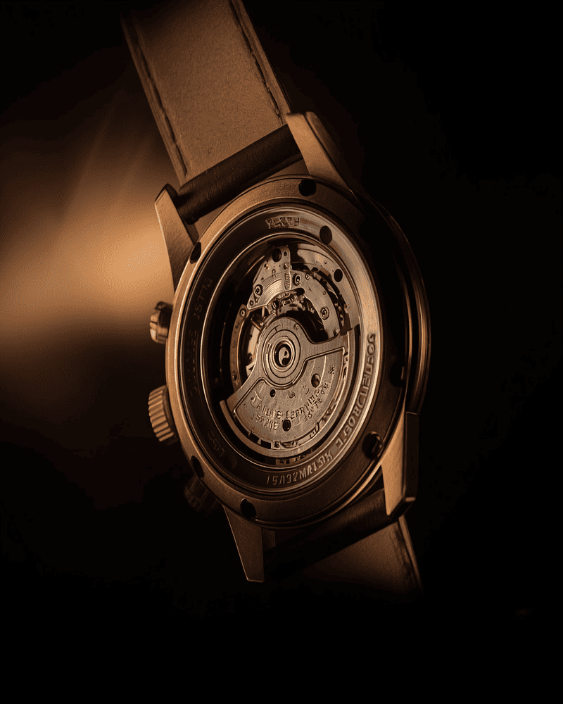 Close-up of a mechanical watch movement through the case back
